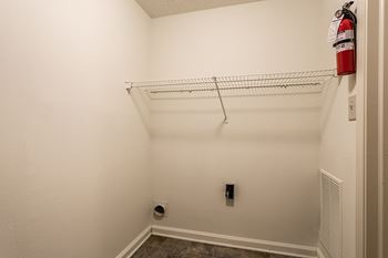an empty closet with a fire extinguisher on the wall at Pheasant Run in Lafayette, IN 47909